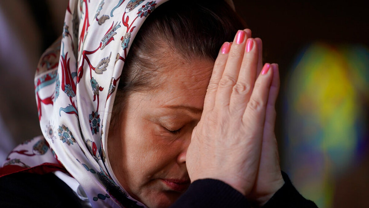 Iryna Hetman-Piatkovska prays for her son who is a soldier in Ukraine during a service for Ukraine at the Saint Andrew Ukrainian Orthodox Church of Los Angeles Sunday, Feb. 27, 2022.