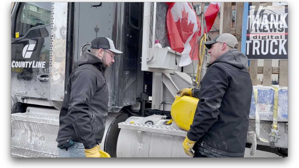 Mark and Michael fill a truck up with gas. 