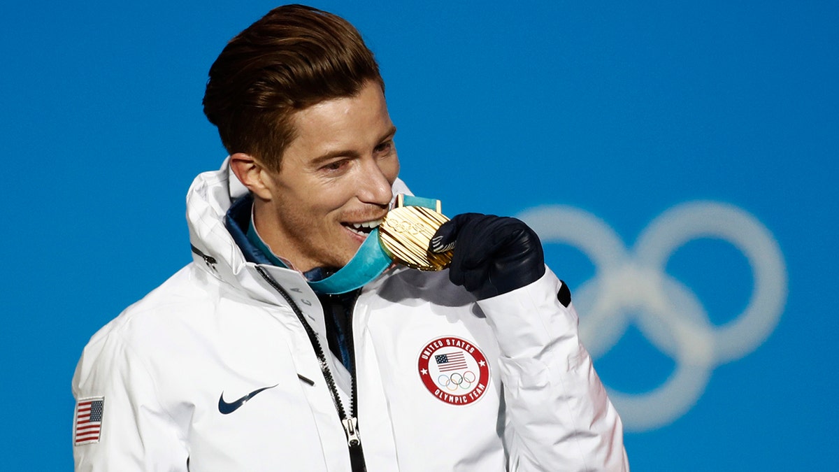 FILE - Men's halfpipe gold medalist Shaun White, of the United States, bites his medal during the medals ceremony at the 2018 Winter Olympics in Pyeongchang, South Korea, Feb. 14, 2018.