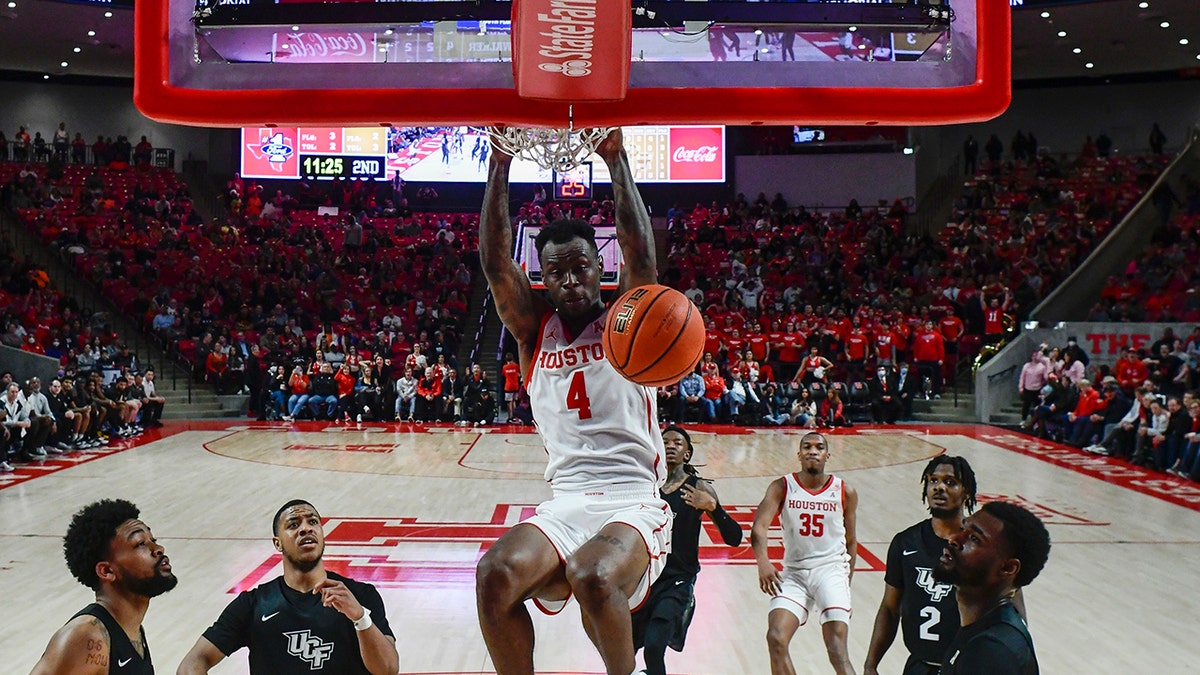 Houston guard Taze Moore (4) dunks the ball against Central Florida during the second half of an NCAA college basketball game Thursday, Feb. 17, 2022, in Houston.