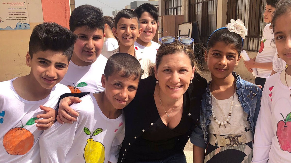 Tina Ramirez, president and executive director of Hardwired Global, meeting with Iraqi kids in Iraq.