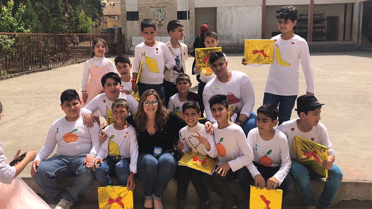 Tina Ramirez, president and executive director of Hardwired Global, meeting with Iraqi kids in Iraq.