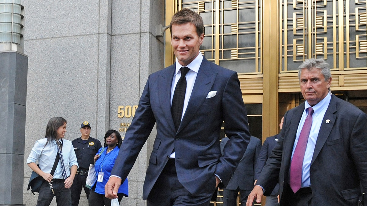 Tom Brady, center, exits federal court in New York on Wednesday, Aug. 12, 2015. 