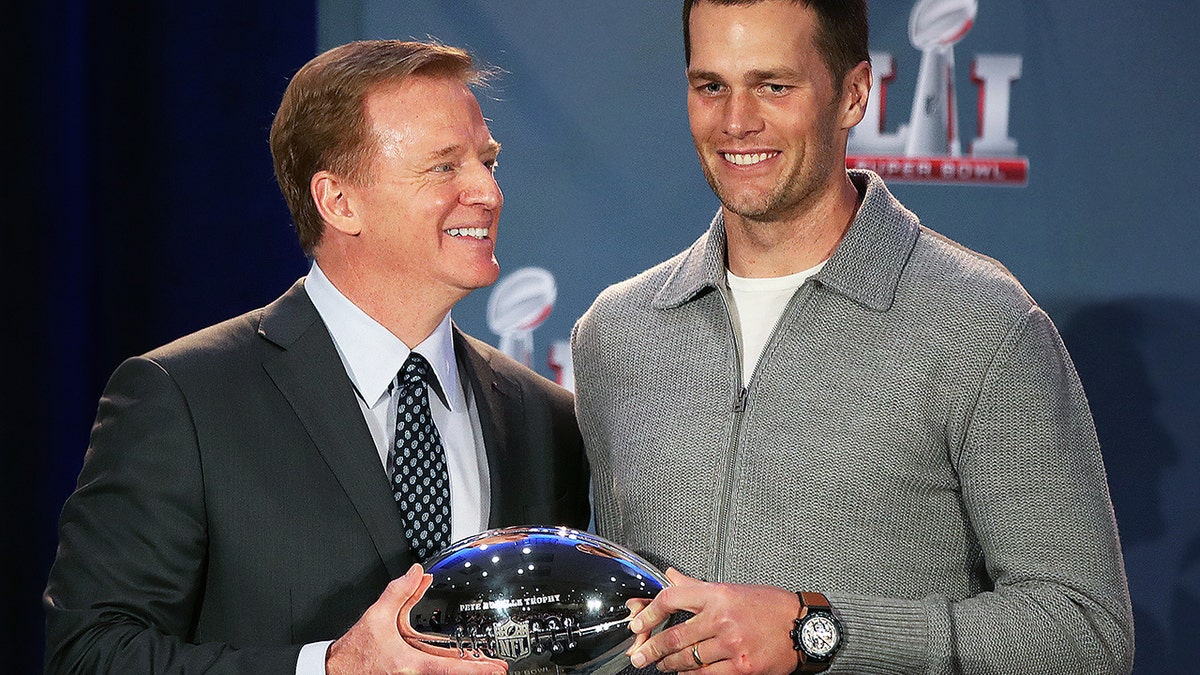 NFL commissioner Roger Goodell presents New England Patriots quarterback Tom Brady the Super Bowl MVP trophy in Houston on Feb. 6, 2017.