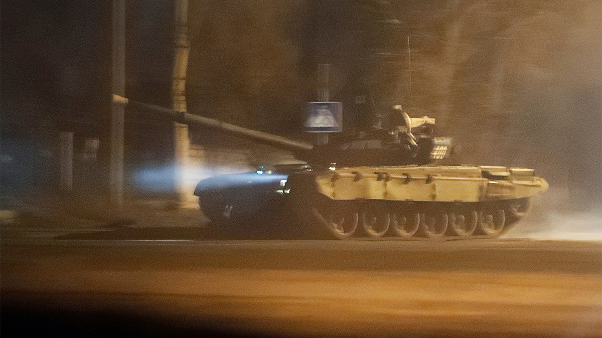 A tank drives along a street in Donetsk, Ukraine, Feb. 22, 2022. 