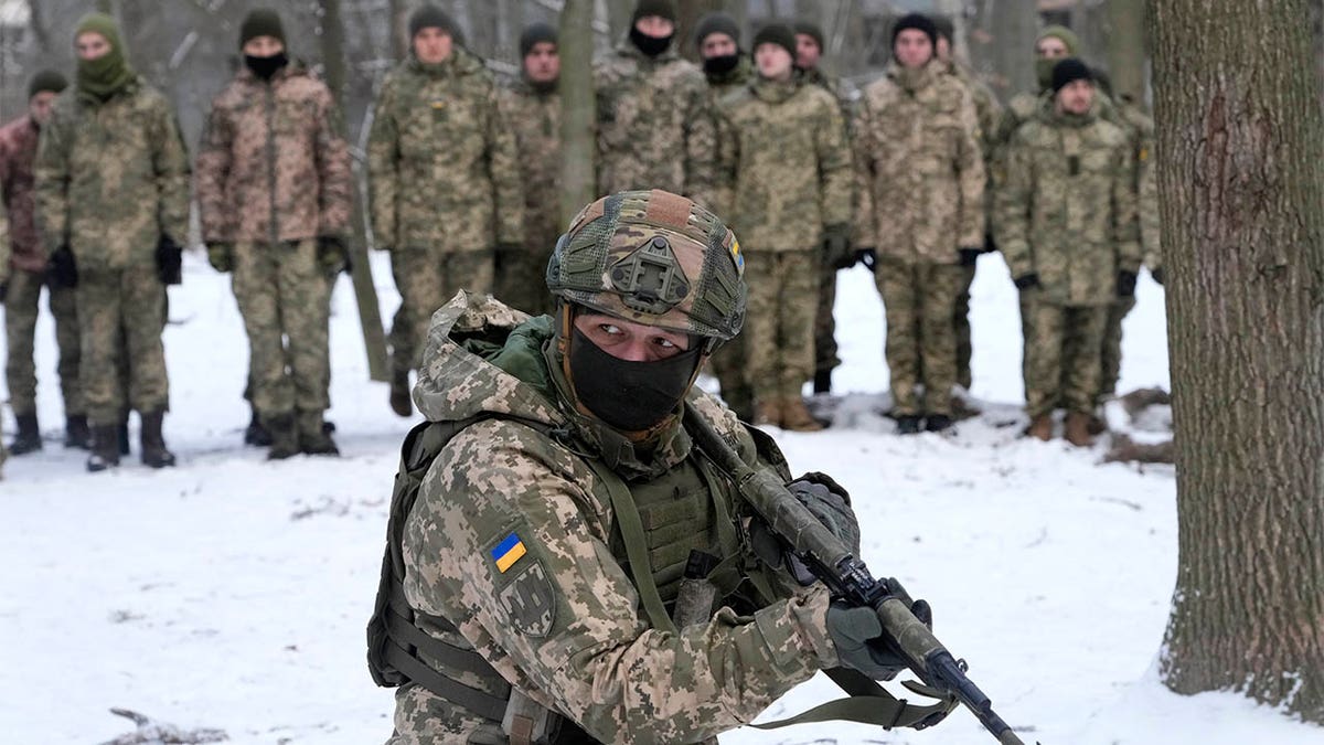 An instructor trains members of Ukraine's Territorial Defense Forces, volunteer military units of the Armed Forces, in a city park in Kyiv, Ukraine, Saturday, Jan. 22, 2022. 