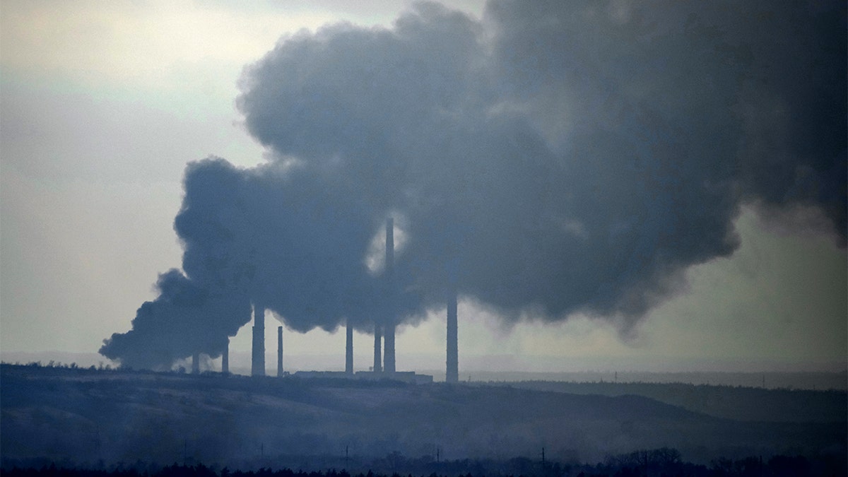 Smoke billows from a power and heating plant after it was shelled in Shchastya, in the Luhansk region, eastern Ukraine, Tuesday, Feb. 22, 2022.