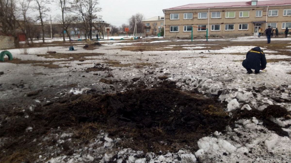 A view shows a crater, caused by shelling according to Ukraine's local officials, at the compound of a lyceum in the town of Vrubivka, in the Luhansk region, Ukraine.