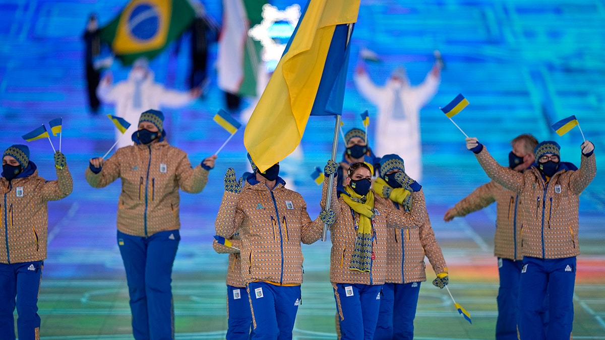 Oleksandr Abramenko and Oleksandra Nazarova, of Ukraine, lead their team in during the opening ceremony of the 2022 Winter Olympics, Friday, Feb. 4, 2022, in Beijing.