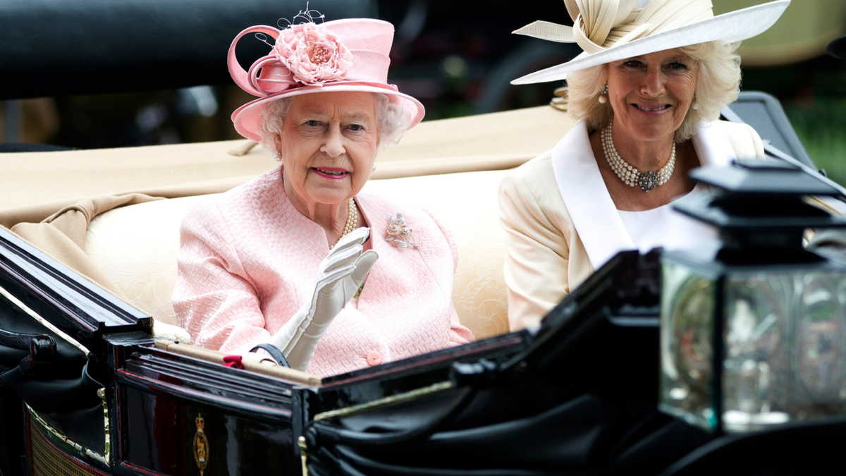 ?Britain's Queen Elizabeth II waves to the crowds with Camilla, Duchess of Cornwall at right, as they arrive by carriage on the first day of the Royal Ascot horse race meeting in Ascot, England.