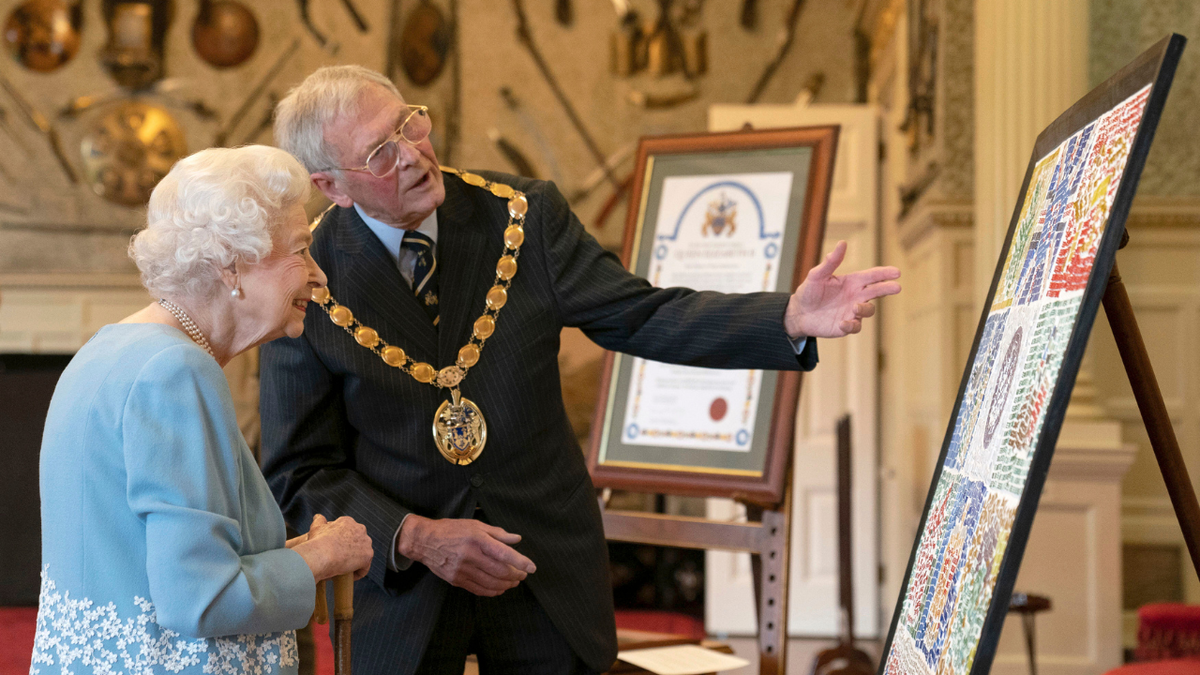 Britain's Queen Elizabeth II, left, attends a reception to celebrate the start of the Platinum Jubilee, at Sandringham House, her Norfolk residence, in Sandringham, England, Saturday, Feb. 5, 2022. 