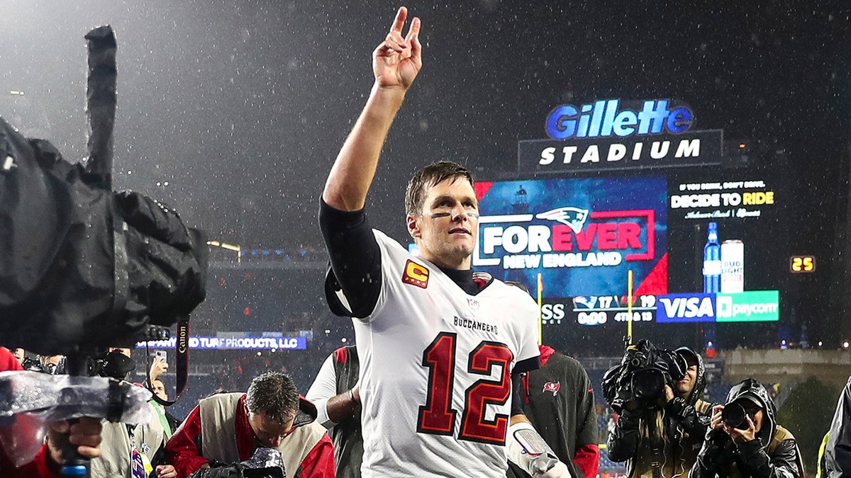 FOXBOROUGH, MASSACHUSETTS - OCTOBER 03: Tom Brady #12 of the Tampa Bay Buccaneers waves to the crowd as he runs off the field after defeating the New England Patriots in the game at Gillette Stadium on October 03, 2021 in Foxborough, Massachusetts. (Photo by Adam Glanzman/Getty Images)