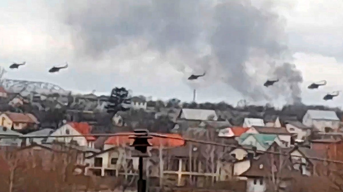 In this handout photo taken from video released by Ukrainian Police Department Press Service, Military helicopters apparently Russian, fly over the outskirts of Kyiv, Ukraine, Thursday, Feb. 24, 2022.