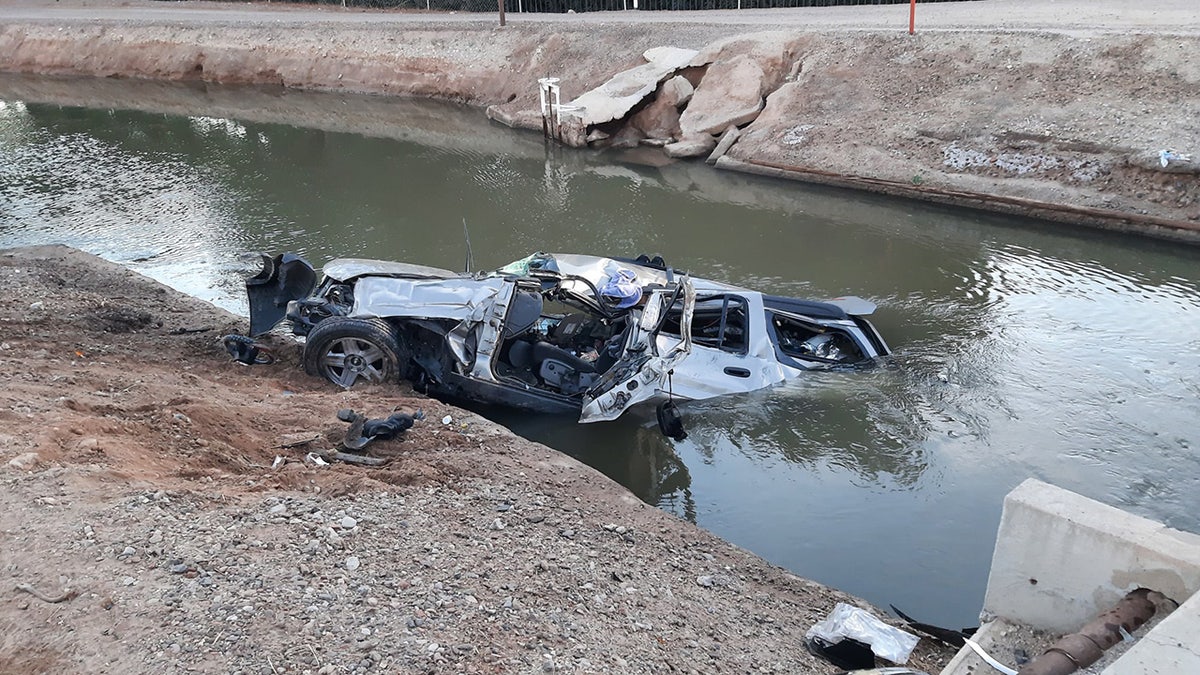 Firefighters in Arizona rescued a person trapped inside a crushed car after it crashed into a canal and began to sink, officials said on Monday.