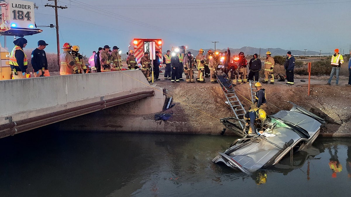 Firefighters in Arizona rescued a person trapped inside a crushed car after it crashed into a canal and began to sink, officials said on Monday.