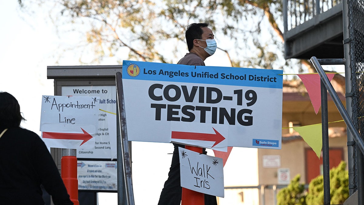 People line up for Covid-19 screening at a testing and vaccination site at a public school in Los Angeles, California, January 5, 2022. (Photo by ROBYN BECK/AFP via Getty Images)