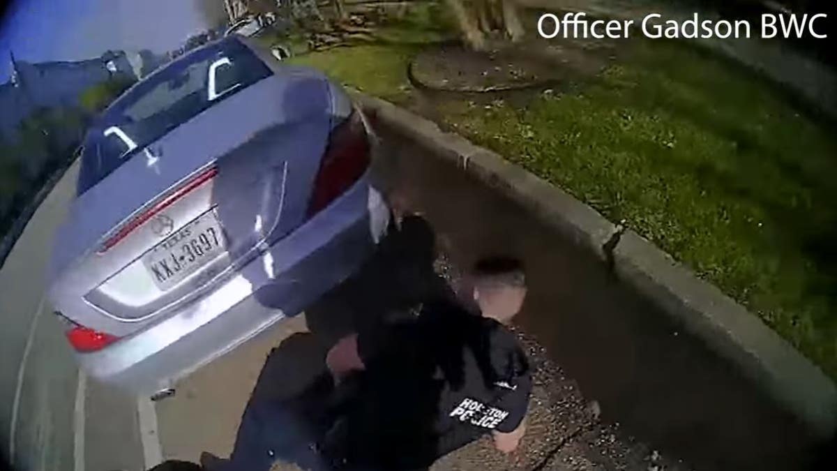 Bodycam footage released Wednesday by the Houston Police Department captured a shootout in which three officers were allegedly wounded by a carjacking suspect. In this image, a wounded officer is seen on the ground.