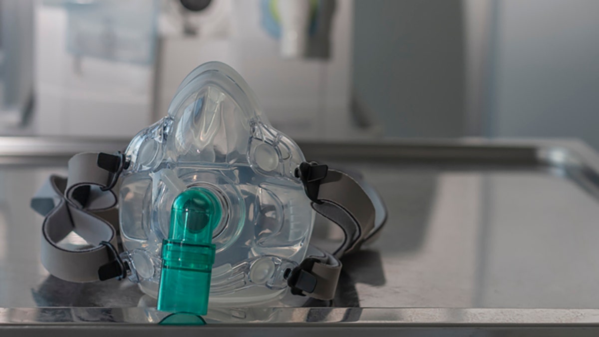 Ventlation face mask, on background medical ventilator in ICU in hospital.