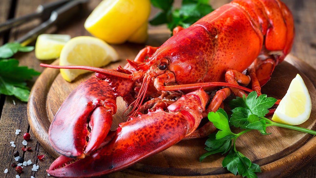 Red lobster on wooden cutting board