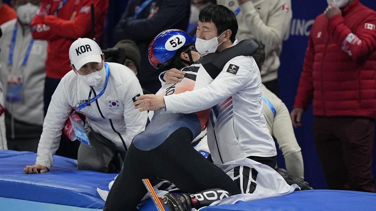Hwang Dae-heon of South Korea, celebrates with teammates after winning his men's 1500-meters final during the short track speedskating competition at the 2022 Winter Olympics, Wednesday, Feb. 9, 2022, in Beijing. 