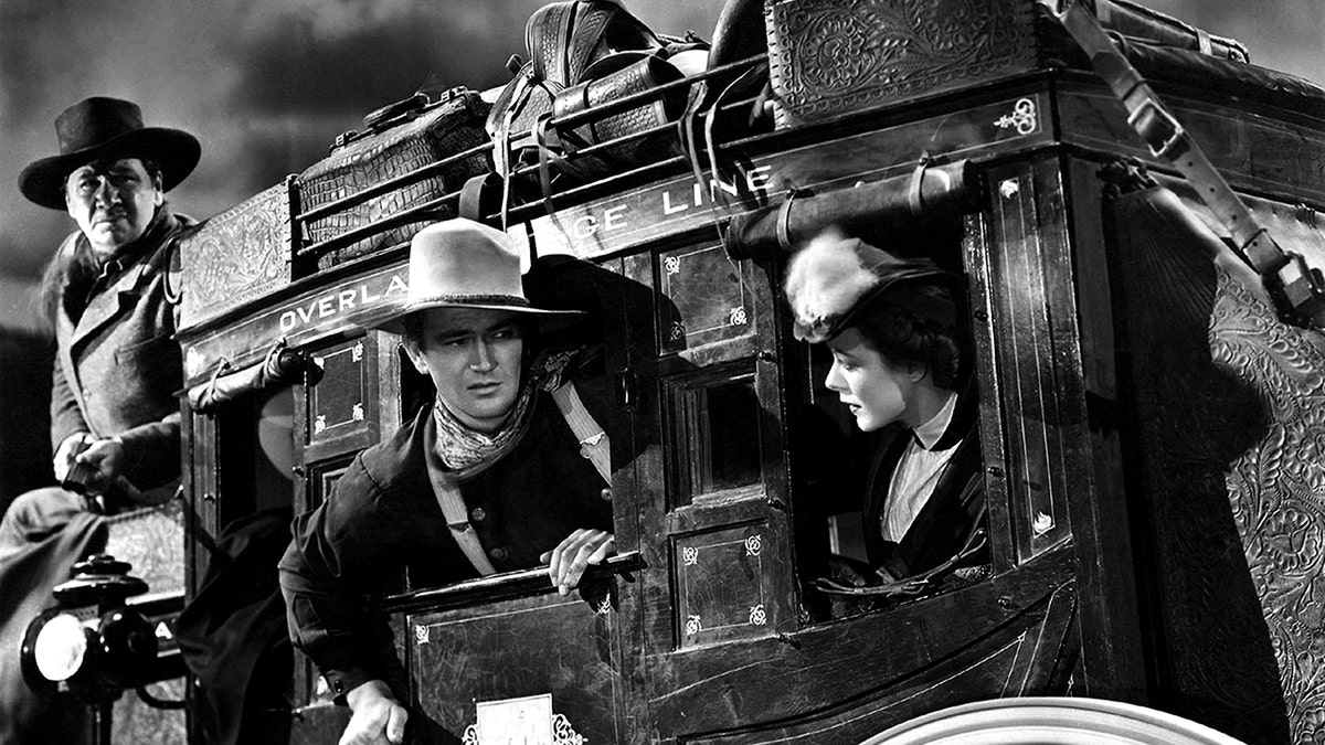 1939: L-R George Bancroft, John Wayne and Louise Platt on the set of the movie 'Stagecoach' in 1939.
