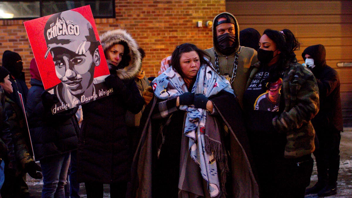 Katie Bryant, Daunte Wright's mother, is surrounded by community members and activists at the apartment building where activists say Hennepin County Judge Regina Chu lives after former officer Kim Potter was sentenced to two years in prison Friday, Feb. 18, 2022, in Minneapolis. 