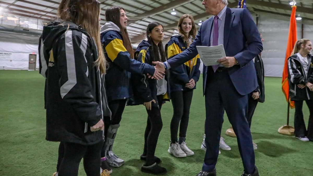 Nassau County Executive Bruce Blakeman meets with cheerleaders.