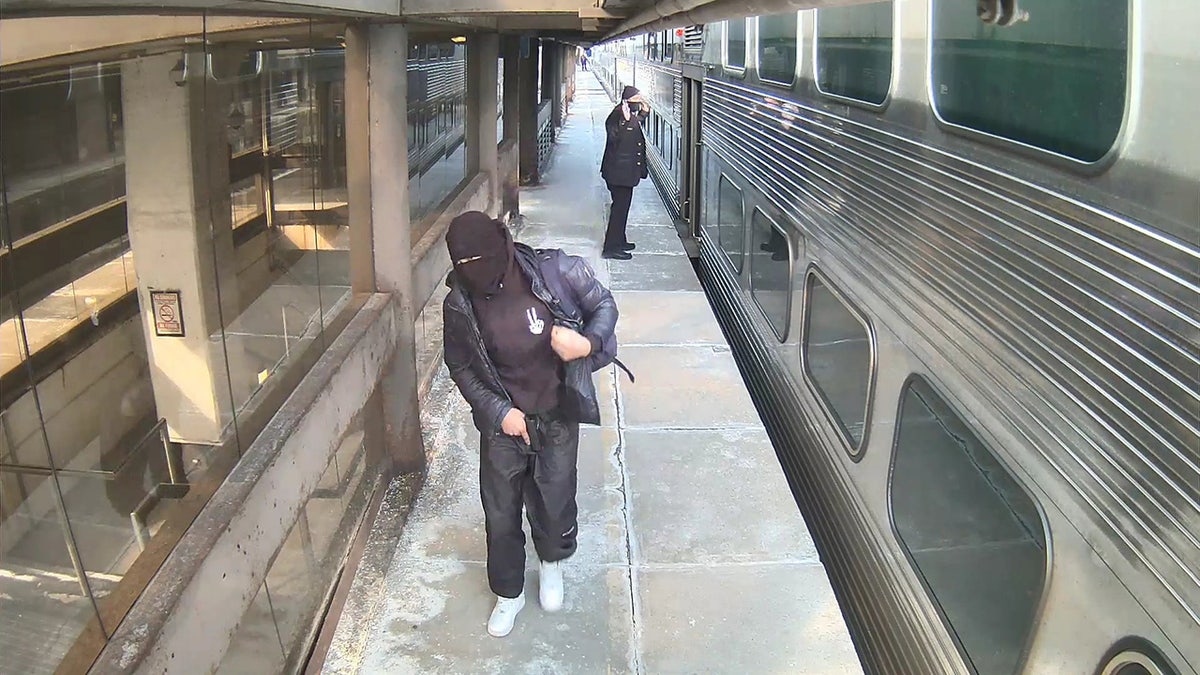 A masked Chicago man held a train conductor at gunpoint Tuesday during a broad daylight robbery at a downtown station stop, authorities said.