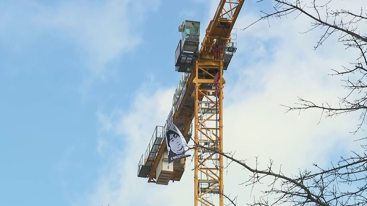 Photo of the protests on a construction crane outside of the White House. 