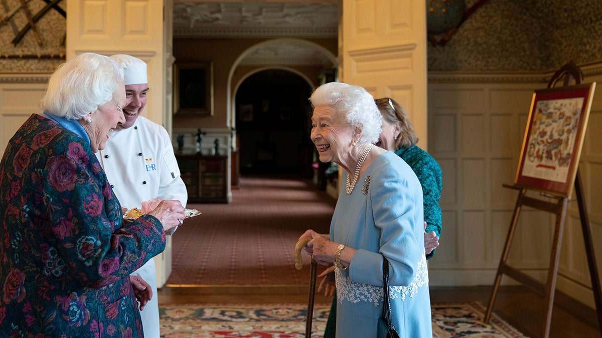 Britain's Queen Elizabeth II meets Angela Wood, the women who helped create coronation chicken, during a reception to celebrate the start of the Platinum Jubilee, at Sandringham House, her Norfolk residence, in Sandringham, England, Saturday, Feb. 5, 2022. 