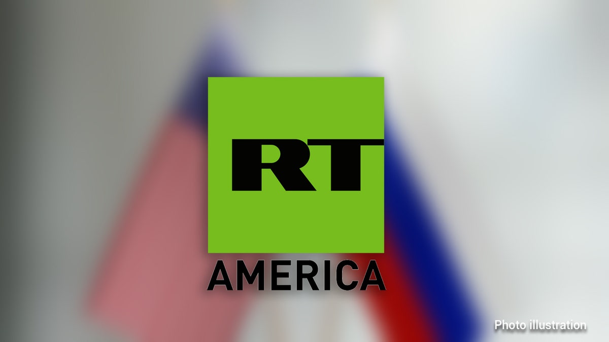 American and Russian flag pair on desk over defocused background. Horizontal composition with copy space and selective focus.
