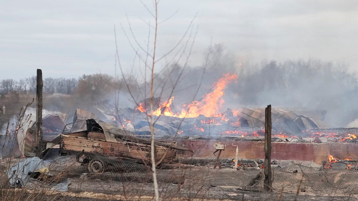 Flame and smoke rise from the debris of a privet house in the aftermath of Russian shelling outside Kyiv, Ukraine, Thursday, Feb. 24, 2022. Russia on Thursday unleashed a barrage of air and missile strikes on Ukrainian facilities across the country.