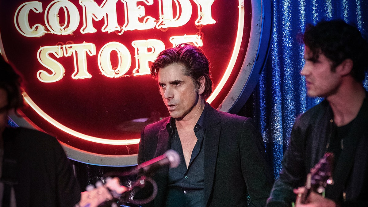 John Stamos on drums and Darren Criss on guitar for the farewell concert at Los Angeles' The Comedy Store in memory of Bob Saget.