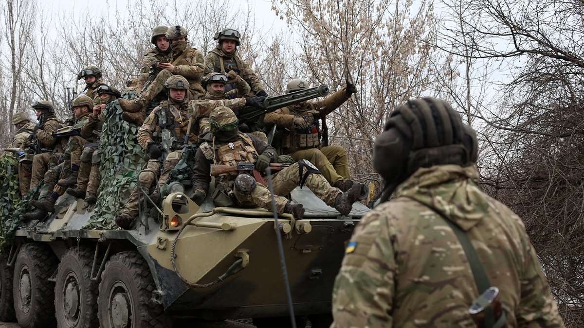 Ukrainian servicemen get ready to repel an attack in Ukraine's Lugansk region on February 24, 2022.