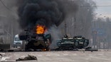 An armored personnel carrier burns and damaged light utility vehicles stand abandoned after fighting in Kharkiv, Ukraine, Sunday, Feb. 27, 2022. The city authorities said that Ukrainian forces engaged in fighting with Russian troops that entered the country's second-largest city on Sunday. (AP Photo/Marienko Andrew)