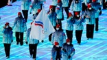 Olga Fatkulina and Vadim Shipachyov, of the Russian Olympic Committee, carry a flag into the stadium during the opening ceremony of the 2022 Winter Olympics, Friday, Feb. 4, 2022, in Beijing.