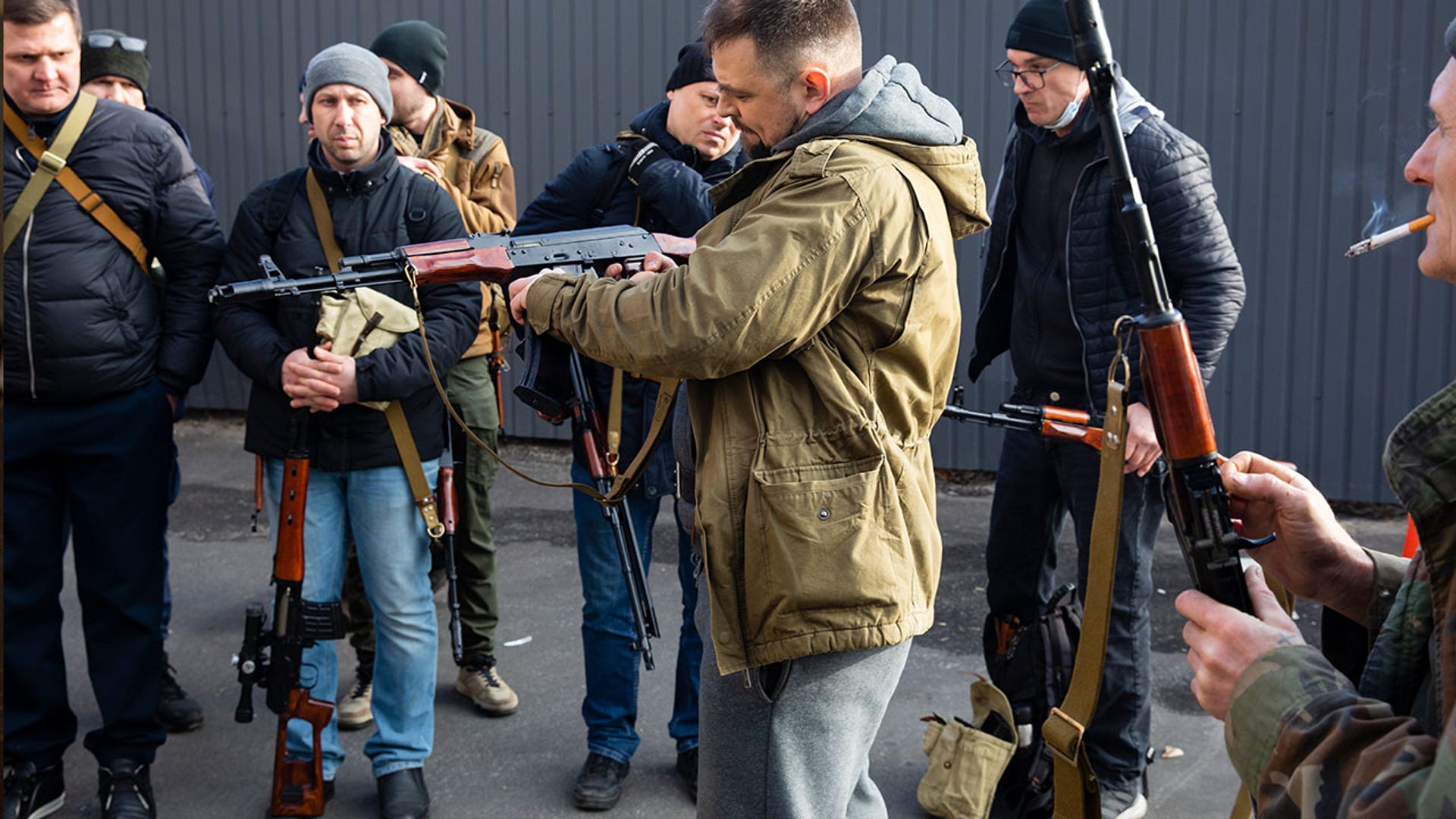Civilian Members of a territorial defence unit fit their weapons to repel the Russian attacking forces in Kyiv, Ukraine, Saturday, Feb. 26, 2022. Russian troops stormed toward Ukraine's capital Saturday, and street fighting broke out as city officials urged residents to take shelter.