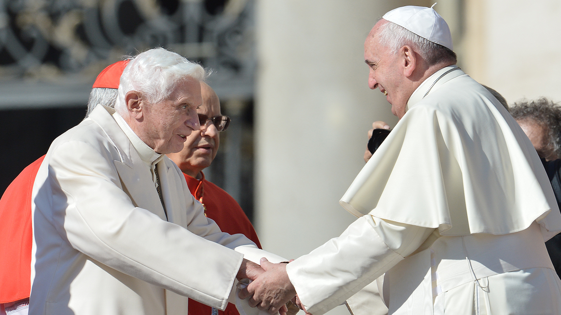 Pope Benedict and Pope Francis hold hands