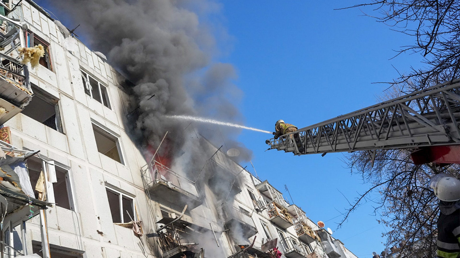 Ukrainian firefighters try to extinguish a fire after an airstrike hit an apartment complex in Chuhuiv, Kharkiv Oblast, Ukraine on February 24, 2022.