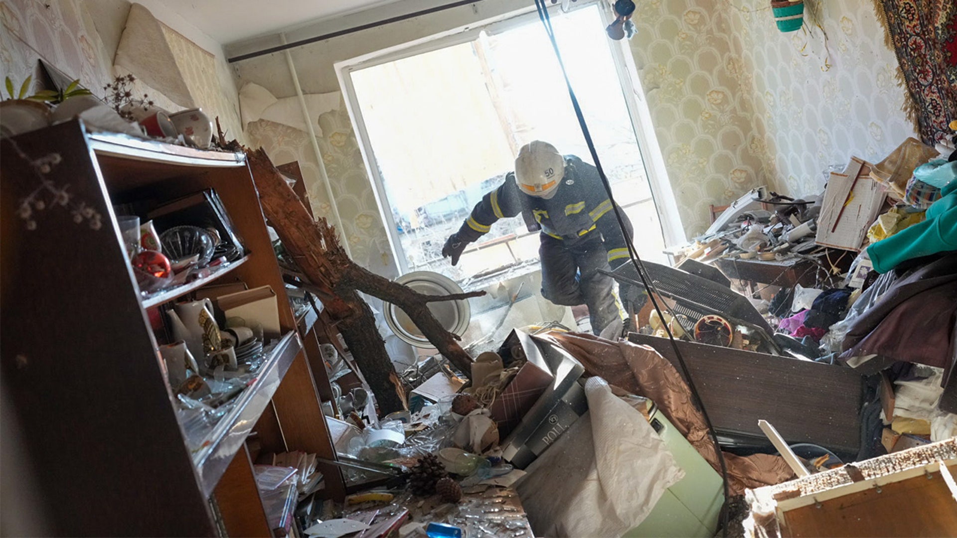Ukrainian firefighters arrive to rescue civilians after an airstrike hit an apartment complex in Chuhuiv, Kharkiv Oblast, Ukraine on February 24, 2022.