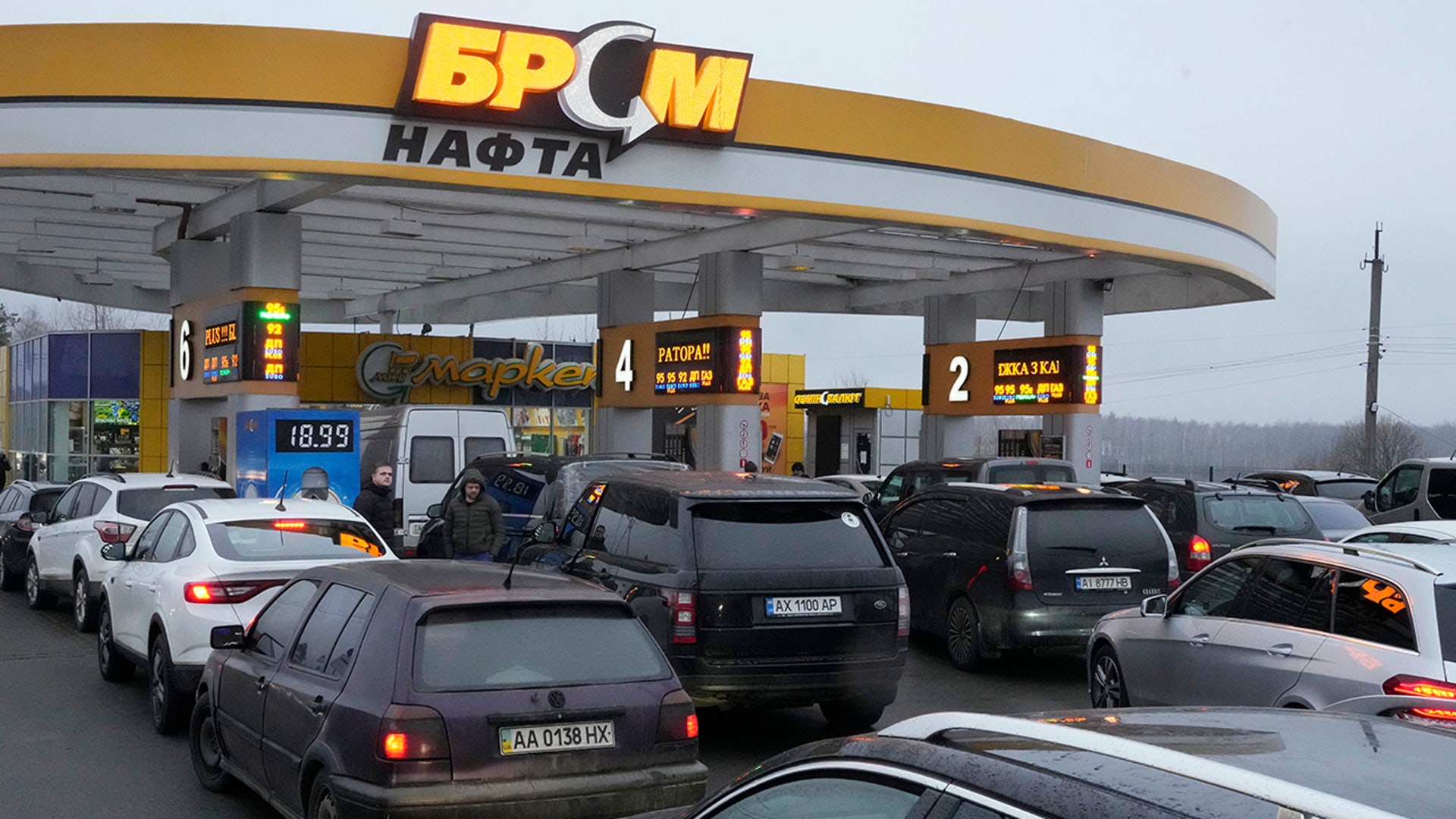 Vehicles line up to a gasoline station in Kyiv, Ukraine, Thursday, Feb. 24, 2022.