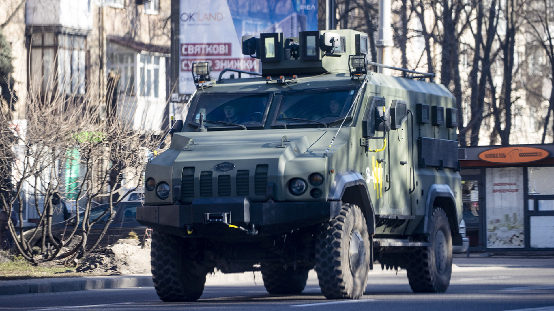 An armored vehicle drives along in Zhuliany neighborhood of Kyiv during Russia's invasion of Ukraine