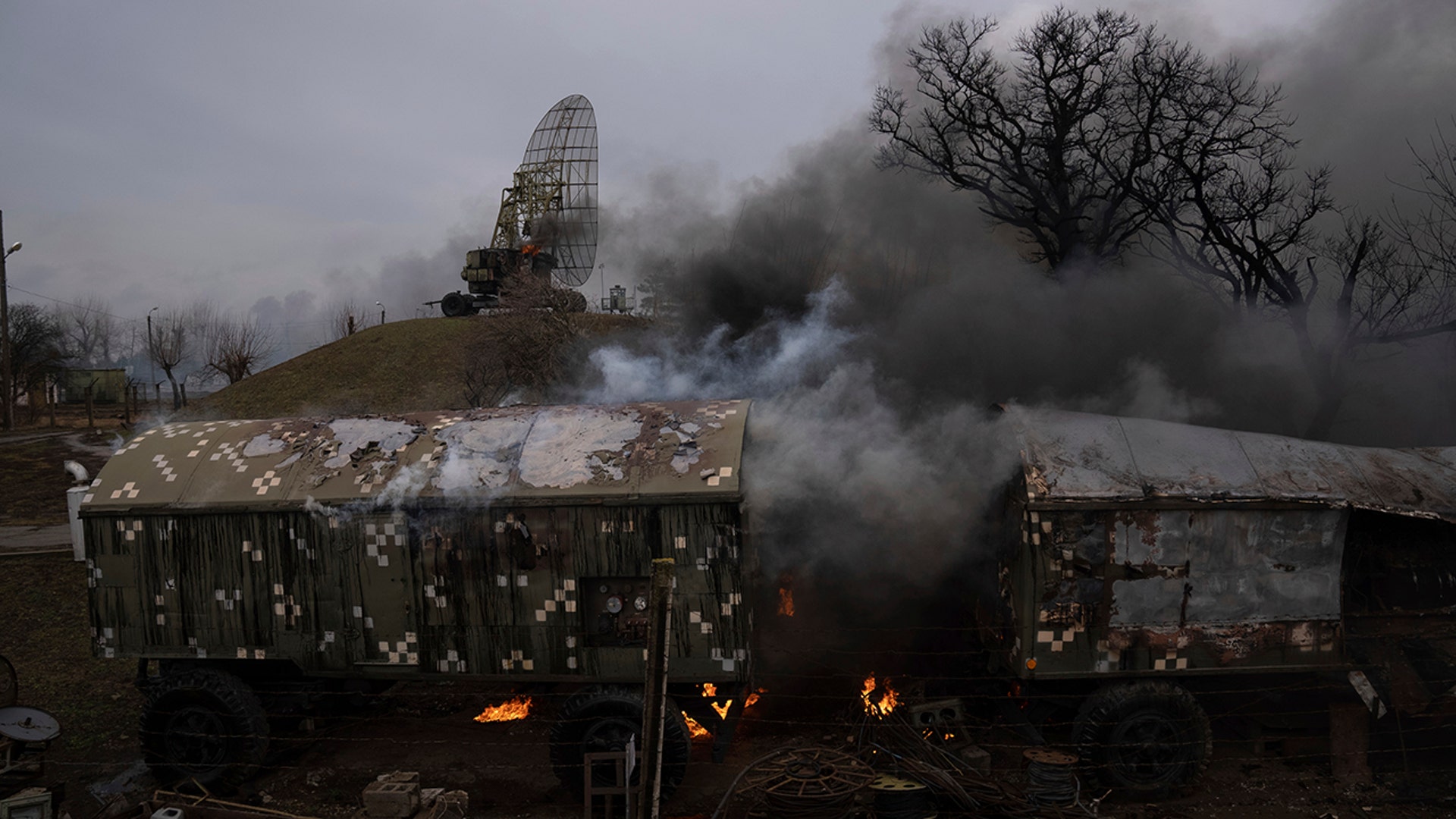 Smoke rise from an air defence base in the aftermath of an apparent Russian strike in Mariupol, Ukraine, Thursday, Feb. 24, 2022. Russian troops have launched their anticipated attack on Ukraine. Big explosions were heard before dawn in Kyiv, Kharkiv and Odesa as world leaders decried the start of Russian invasion that could cause massive casualties and topple Ukraine's democratically elected government. (AP Photo/Evgeniy Maloletka)