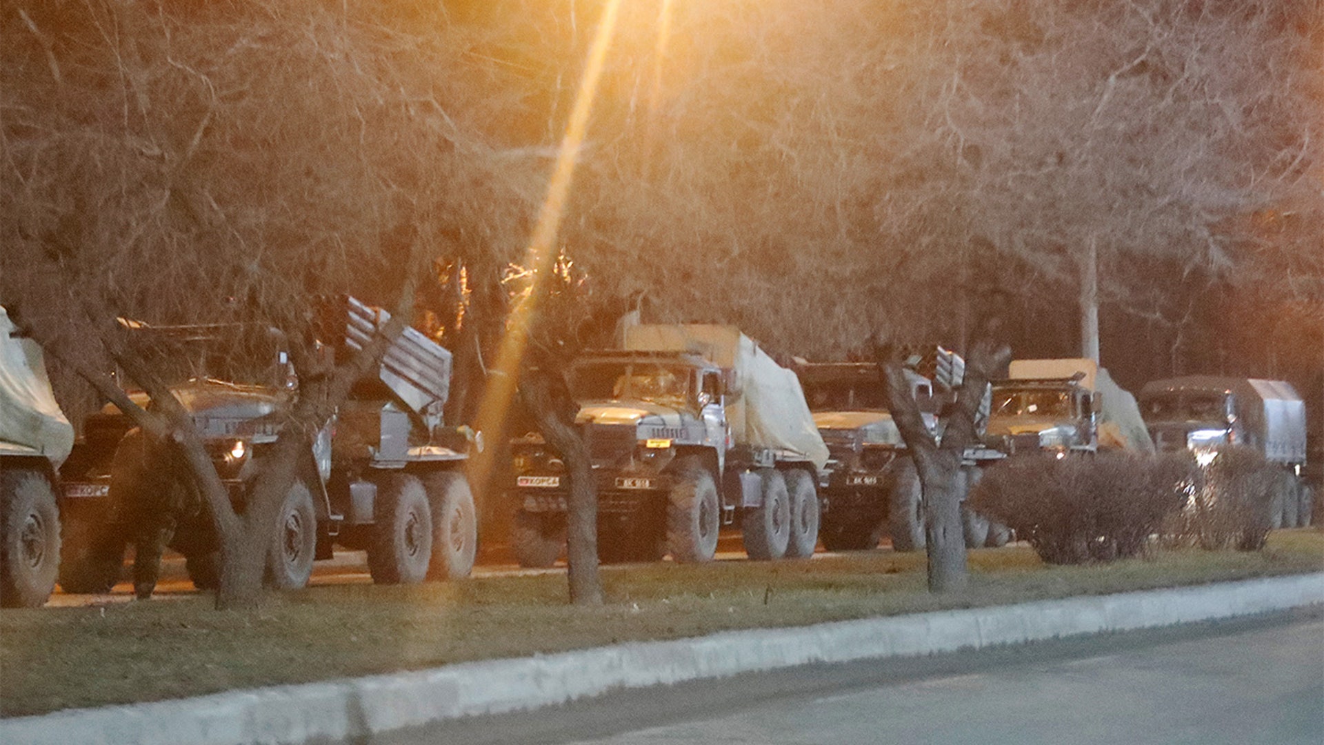Military vehicles are seen on a street on the outskirts of the separatist-controlled city of Donetsk, Ukraine February 23, 2022.