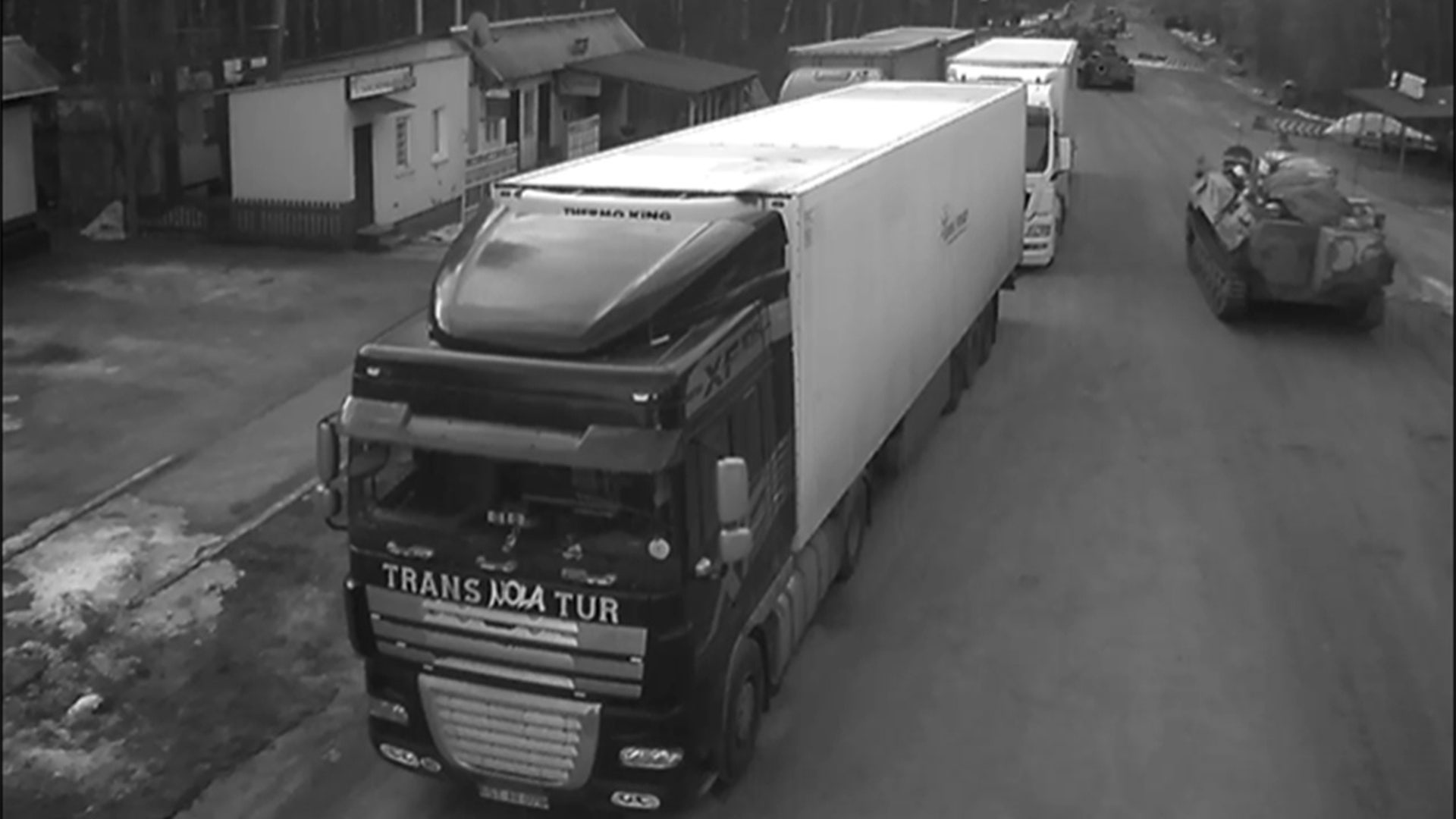Military vehicles roll through border crossing at Sen'kivka, Ukraine, near the border with Belarus.