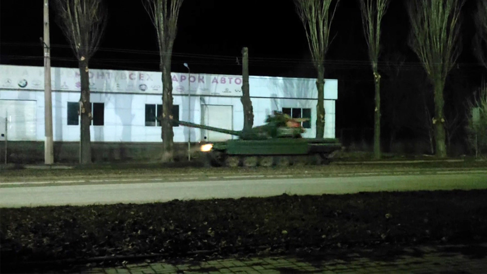 A screen grab captured from a video shows Russian military tanks advance in the Russian separatist-controlled part of the Donbas region on February 23, 2022.