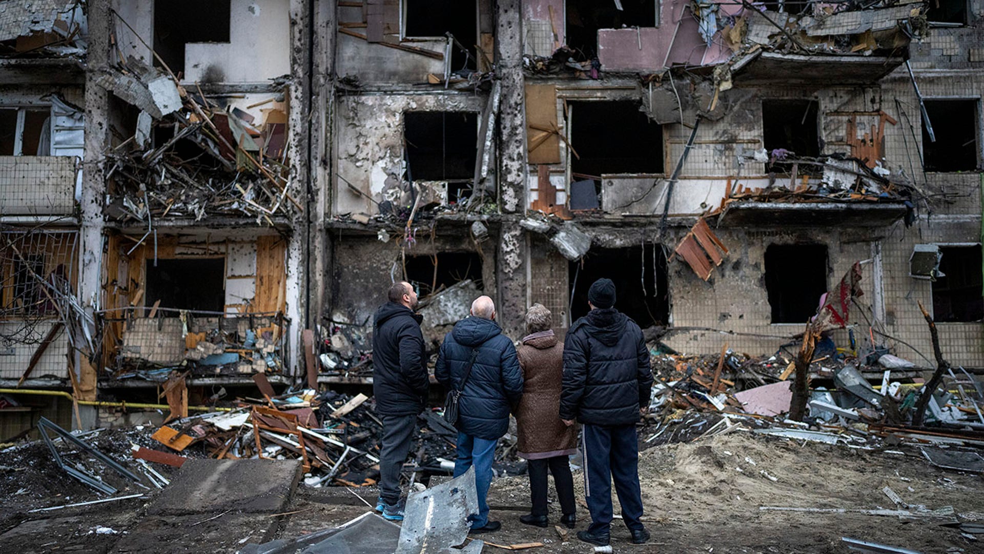 People look at the damage following a rocket attack the city of Kyiv, Ukraine, Friday, Feb. 25, 2022. (AP Photo/Emilio Morenatti)