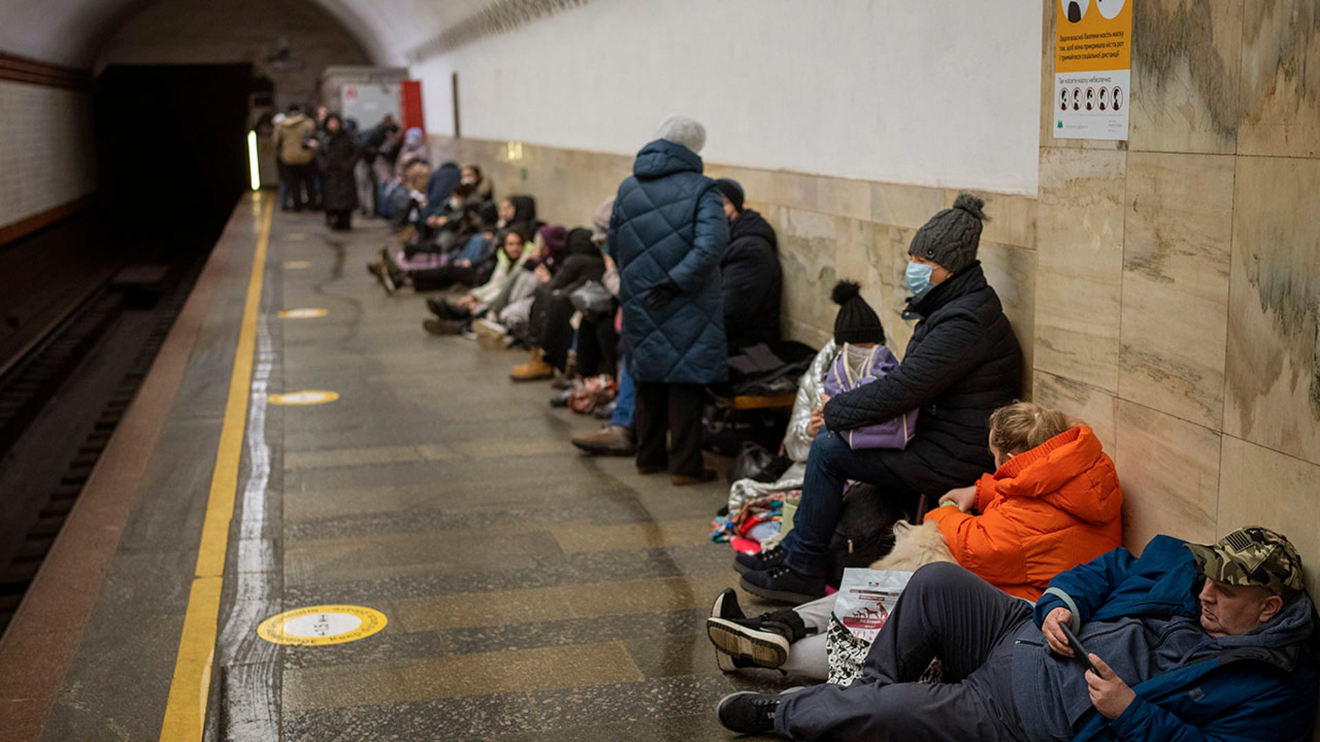 People lie in the Kyiv subway, using it as a bomb shelter in Kyiv, Ukraine, Thursday, Feb. 24, 2022. Russia has launched a full-scale invasion of Ukraine, unleashing airstrikes on cities and military bases and sending troops and tanks from multiple directions in a move that could rewrite the world's geopolitical landscape. (AP Photo/Emilio Morenatti)