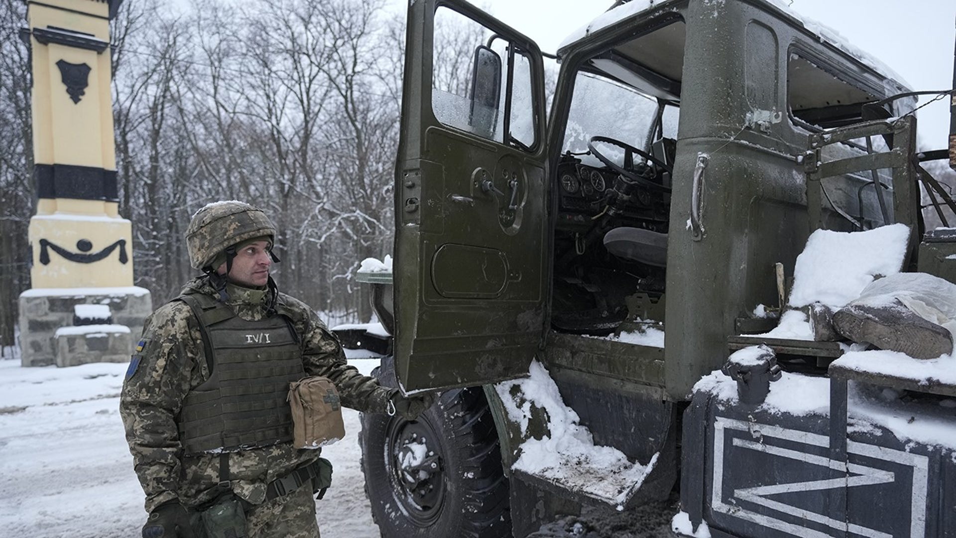 A Ukrainian servicemen opens the door of a deactivated Russian military multiple rocket launcher on the outskirts of Kharkiv, Ukraine, Friday, Feb. 25, 2022. Russian troops bore down on Ukraine's capital Friday, with gunfire and explosions resonating ever closer to the government quarter, in an invasion of a democratic country that has fueled fears of wider war in Europe and triggered worldwide efforts to make Russia stop.