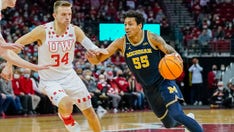 Michigan coach Juwan Howard appears to throw punch at Wisconsin assistant, brawl breaks out between players